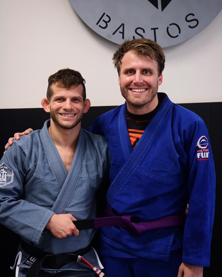 Picture of Alex Cerjan being promoted to purple belt by Milton Bastos.